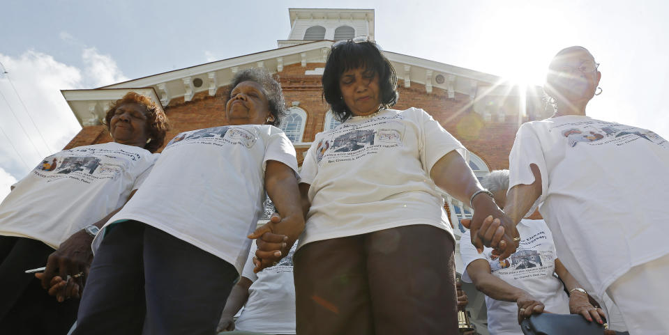 FILE - Members of the Dexter Avenue King Memorial Baptist Church pray during a bell ringing ceremony in Montgomery, Ala., Wednesday, Aug. 28, 2013. The ceremony honors the 50th anniversary of the March on Washington and the "I Have a Dream" speech by Rev. Martin Luther King Jr., who was pastor at this church in 1954. (AP Photo/Dave Martin, File)