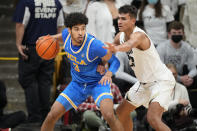 UCLA guard Johnny Juzang, left, is defended by Colorado forward Tristan da Silva during the second half of an NCAA college basketball game Saturday, Jan. 22, 2022, in Boulder, Colo. UCLA won 71-65. (AP Photo/David Zalubowski)