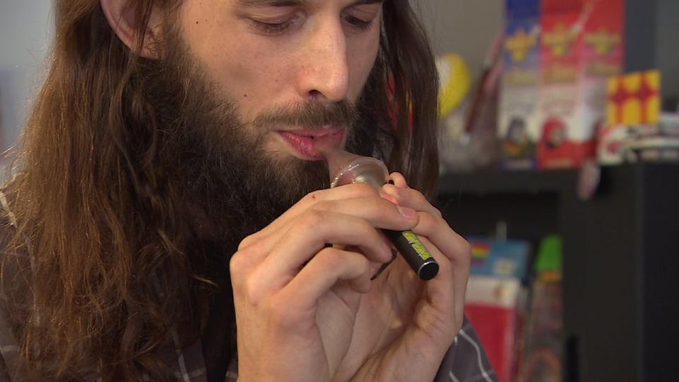 Christopher Enns demonstrates a vaporizer for marijuana.
