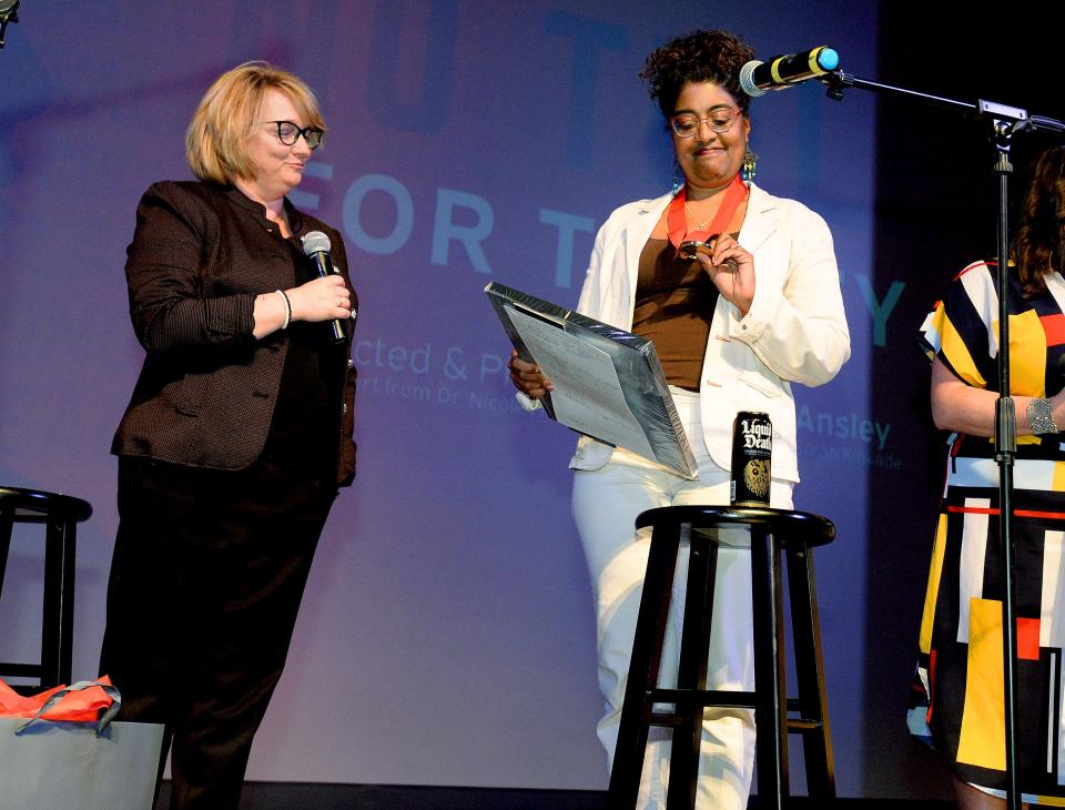 Tracey Meares, right, holds a certificate for the1984 valedictorian and looks at the valedictorian medal, both given to her by Superintendent of Springfield Public Schools District 186 Jennifer Gill  after the showing of the documentary "No Title for Tracey" at the Hoogland Center for the Arts Saturday April 16, 2022. The documentary tells the story how Meares had lost out on being the Springfield High School's first Black Valedictorian despite recording the top grade point average. [Thomas J. Turney/The State Journal-Register]