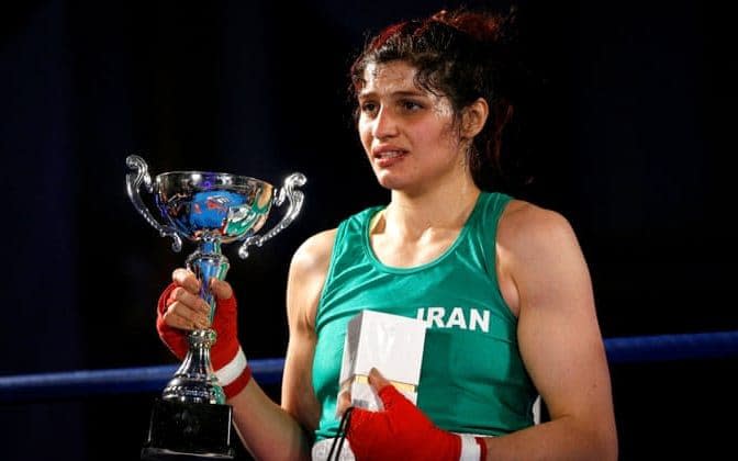 Sadaf Khadem is presented with the trophy after beating Anne Chauvin in their boxing match in Royan.  - Reuters