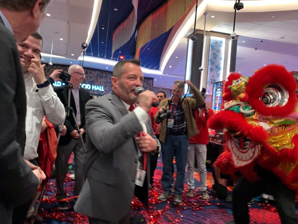 Tony Rohrer, Bally's regional vice president and general manager, with a lion dancer at Twin River.