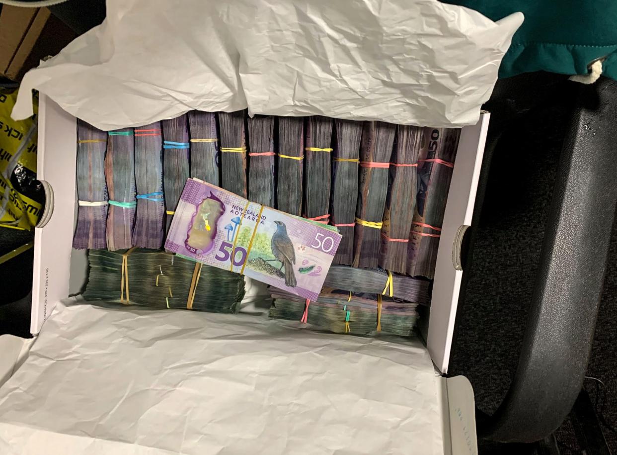 In this undated photo supplied by the New Zealand police, a box containing a large amounts of cash is seen after being discovered during a police raid as part of Operation Trojan.