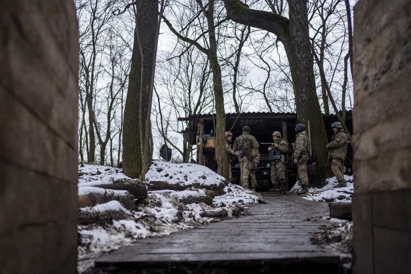 Soldiers of Ukraine's state border guard discuss the agenda at a military position in the Sumy region, Ukraine, Friday, Nov. 24, 2023.