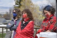 Women listen to speakers during a ceremony to commemorate missing and murdered indigenous people in front of the Montana state Capitol in Helena, Mont., Wednesday, May 5. 2021. From Washington to Indigenous communities across the American Southwest, top government officials, family members and advocates gathered Wednesday as part of a call to action to address the ongoing problem of violence against Indigenous women and children. (AP Photo/Iris Samuels)