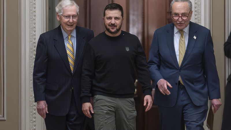 Ukrainian President Volodymyr Zelenskyy, center, is escorted by Senate Minority Leader Mitch McConnell, R-Ky., left, and Senate Majority Leader Chuck Schumer, D-N.Y., and as visits the Capitol in Washington to issue a plea for Congress to break its deadlock and approve continued wartime funding for Ukraine on Tuesday, Dec. 12, 2023.