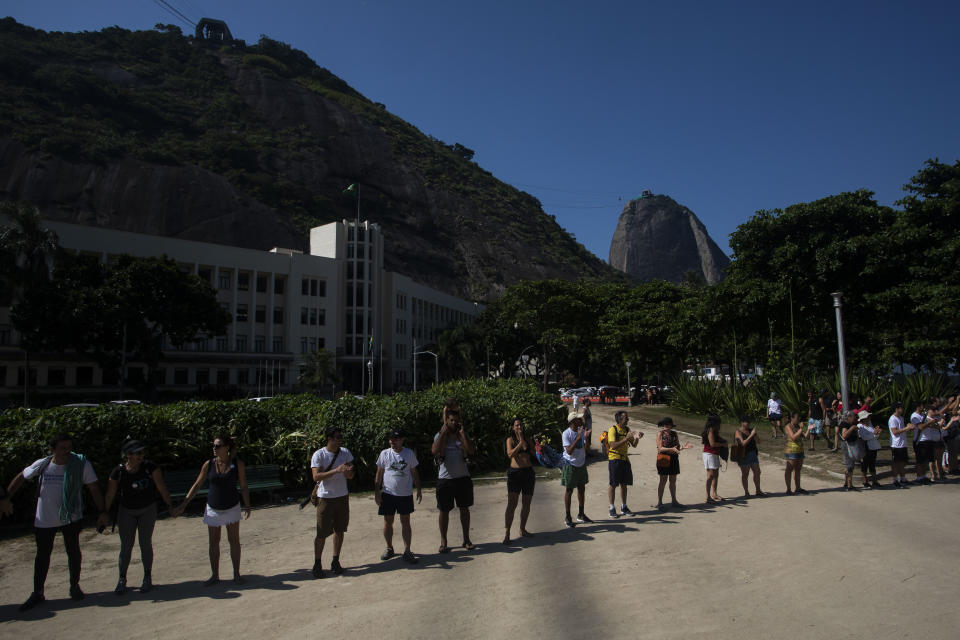 Residents and activists protest against the installation of a zip line on Sugar Loaf Mountain, an icon of the city and a UNESCO World Heritage Site, in Rio de Janeiro, Brazil, Sunday, March 26, 2023. (AP Photo/Bruna Prado)