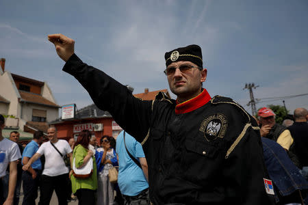 A supporters of Serbian Radical Party leader Vojislav Seselj wearing "Chetnik" uniform salutes during a protest in the village of Jarak, near Hrtkovci, Serbia, May 6, 2018. REUTERS/Marko Djurica