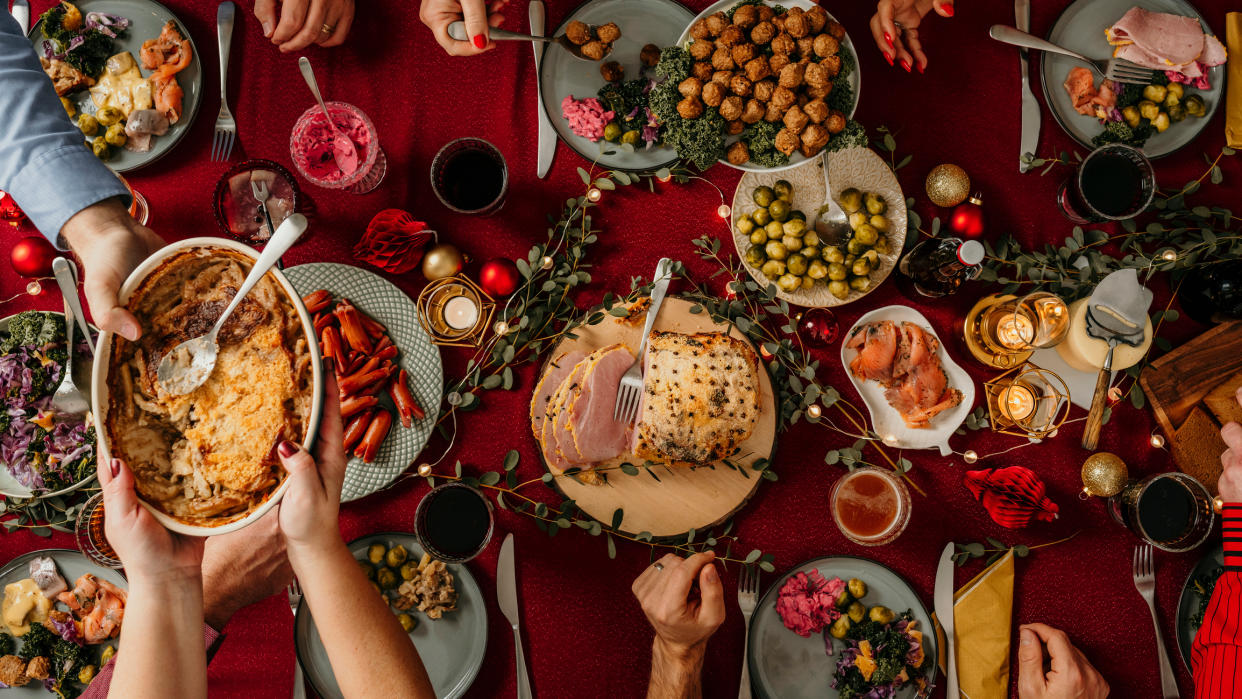  Birds-eye-view of Christmas table with lots of food. 