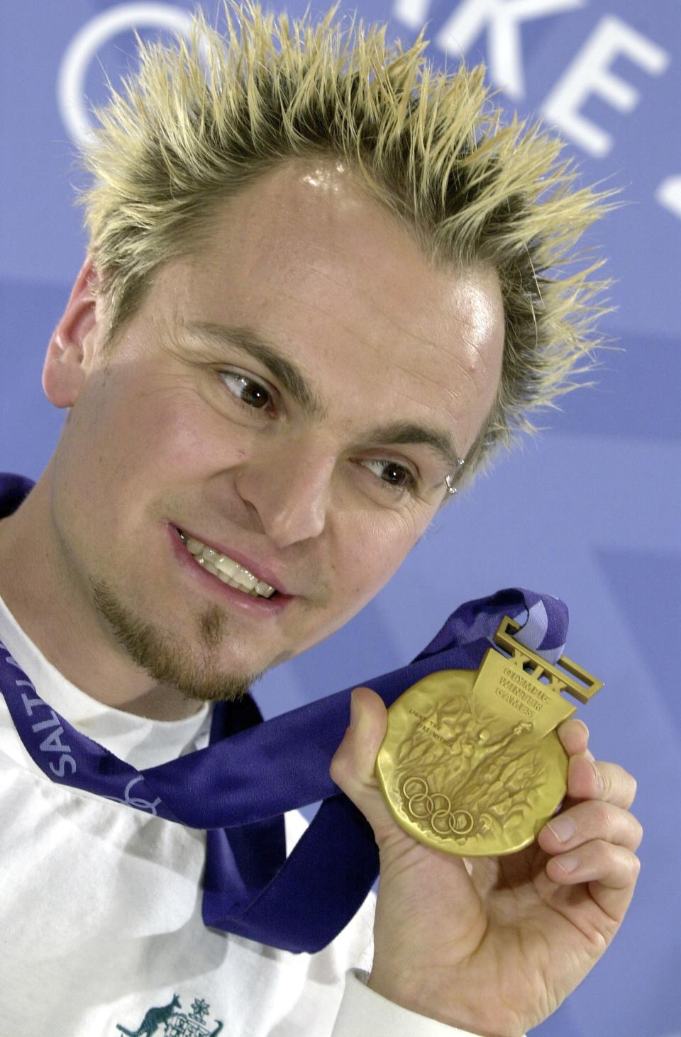 FILE - Steven Bradbury Australia's surprise gold medalist in 1000 metres short track speed skating event displays his medal at a press conference in Salt Lake City, Sunday, Feb. 17, 2002. Bradbury has been presented with a bravery award by the Queensland state governor in Brisbane for rescuing four teenagers from rough seas at a beach at Caloundra north of Brisbane in March of last year. (AP Photo/Peter Dejong, File)