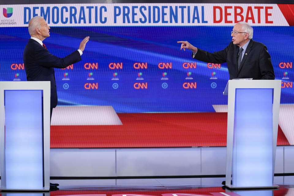 FILE - Former Vice President Joe Biden, left, and Sen. Bernie Sanders, I-Vt., right, participate in a Democratic presidential primary debate at CNN Studios in Washington, March 15, 2020. (AP Photo/Evan Vucci, File)