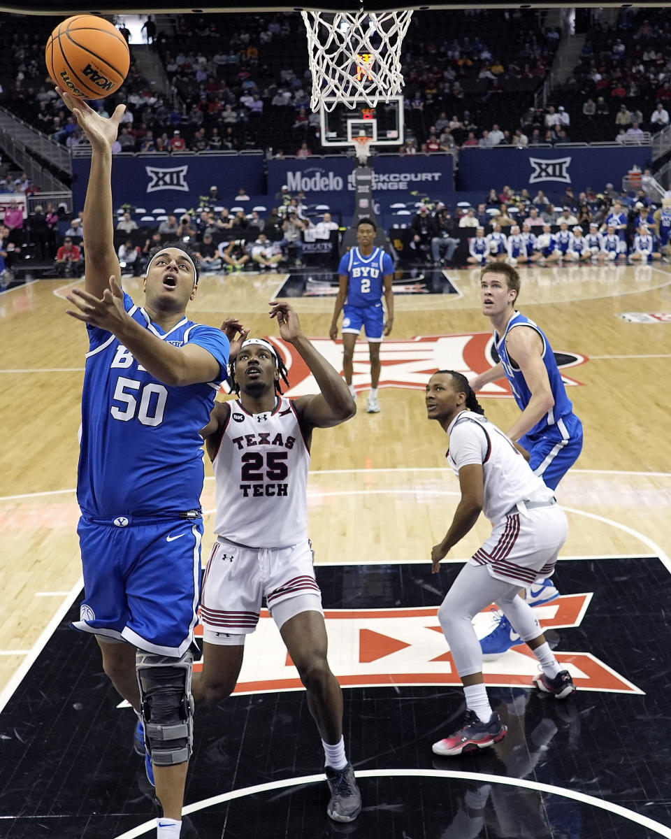 BYU center Aly Khalifa (50) gets past Texas Tech forward Robert Jennings (25) to put up a shot during the first half of an NCAA college basketball game Thursday, March 14, 2024, in Kansas City, Mo. (AP Photo/Charlie Riedel)