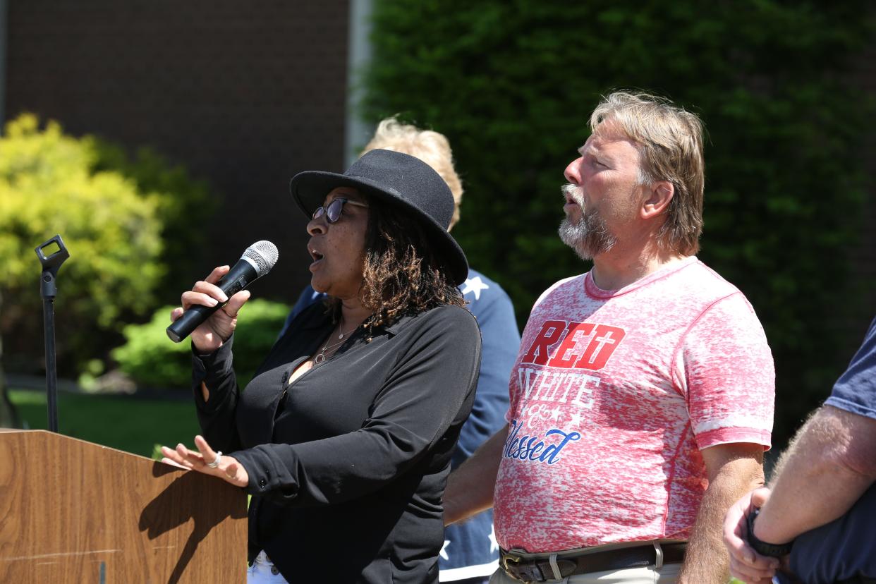 Cynthia and Rex Mason sing "God Bless America" Thursday at the National Day of Prayer service in downtown Fremont.