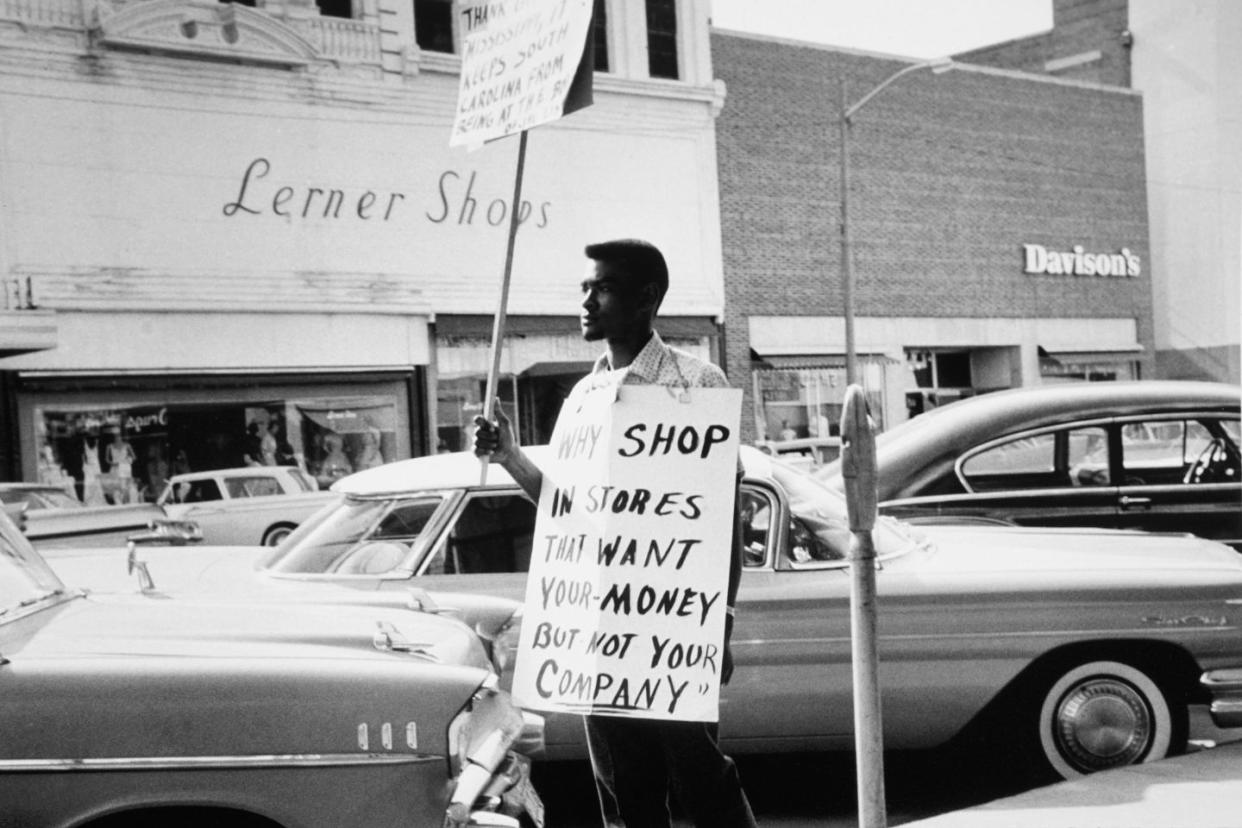 man protesting with sign in downtown Columbia, South Carolina in 1962