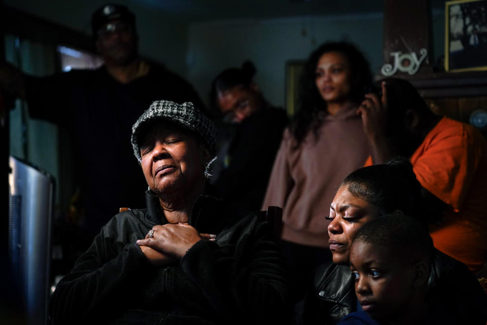 JoAnn Daniels, left, accompanied by, Kayla Jones, lower second from right, Donell Jones, lower right, and other family members, speaks during an interview with The Associated Press about her sister Celestine Chaney, who was killed in Saturday's shooting at a supermarket, in Buffalo, N.Y., Monday, May 16, 2022. (AP Photo/Matt Rourke)