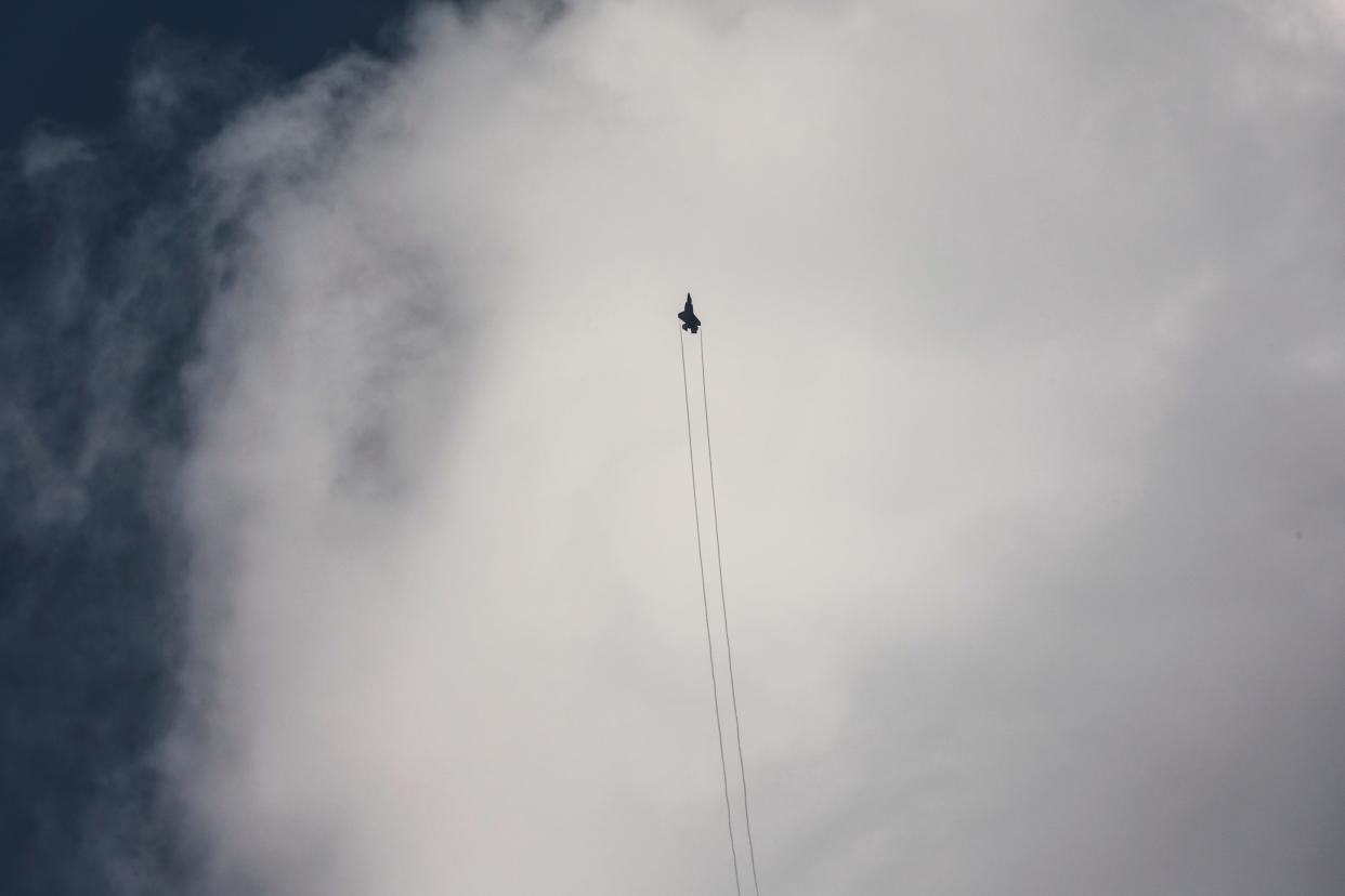 An Israeli F-35 combat aircraft is seen in the skies over Israel's border with Lebanon