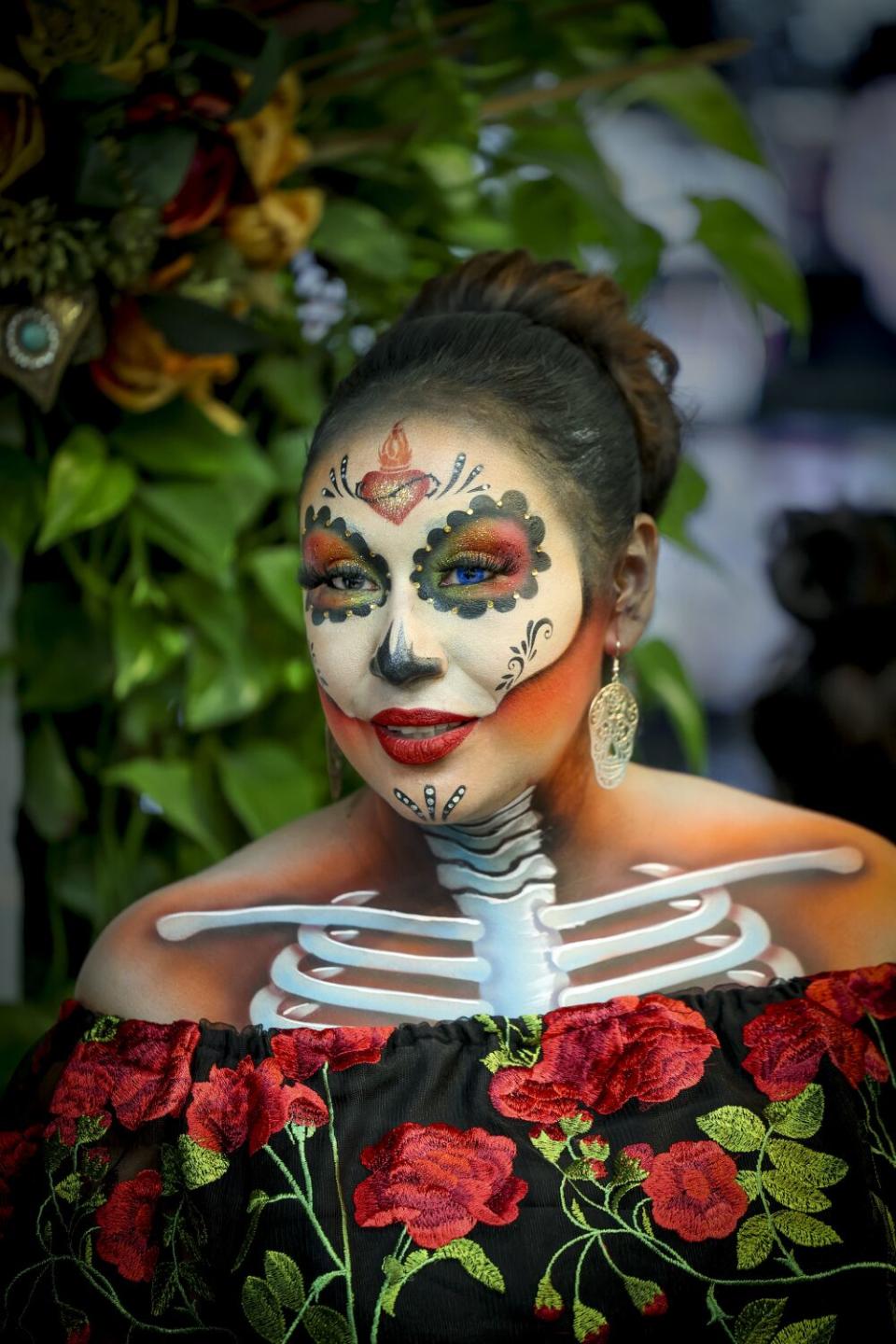 Denise Romero models the makeup work of Ruben López, not pictured, at his studio in Paramount.