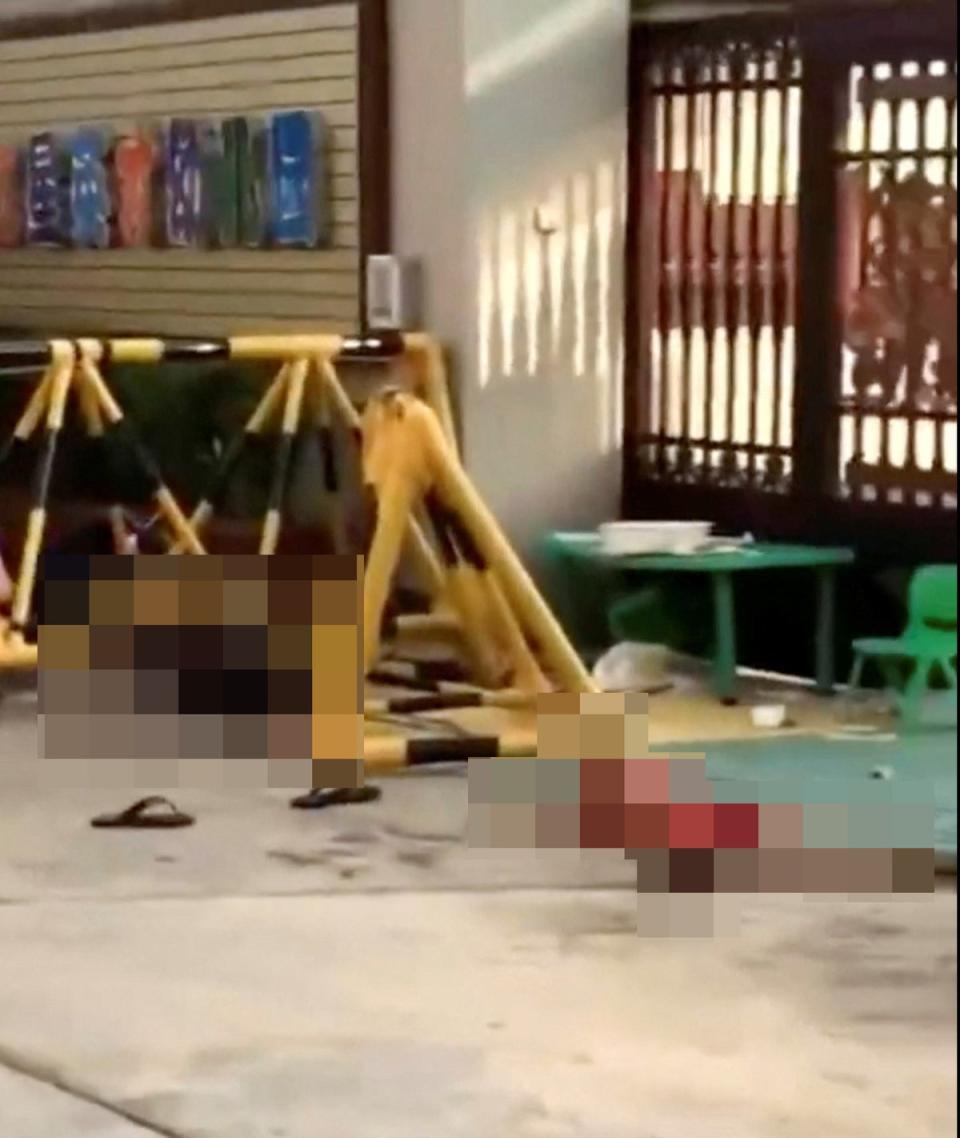 Bodies lie on the ground in the aftermath of a stabbing attack at a kindergarten in Lianjiang county, Guangdong province, China (Video obtained via REUTERS)