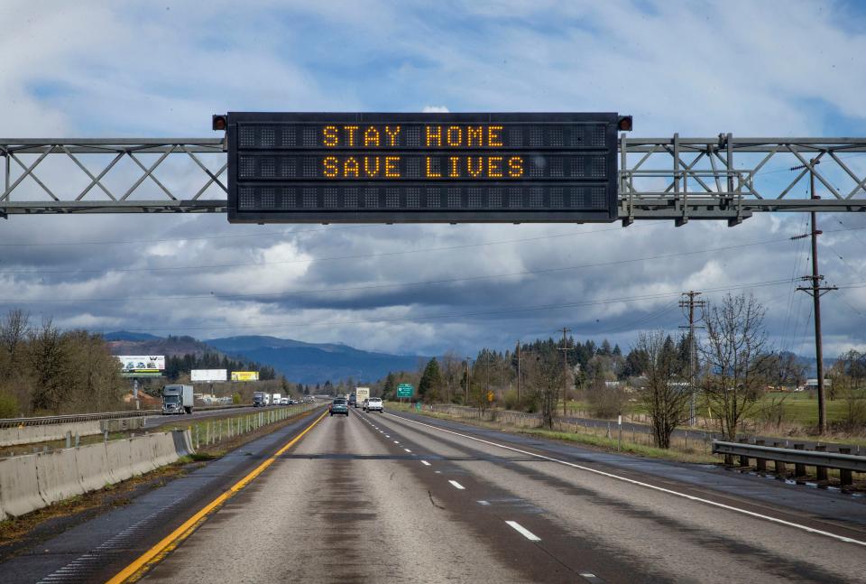 A reader board over Interstate 5 northbound south of Eugene, Ore. encourages motorists to stay at home due to coronavirus Tuesday March 24, 2020.