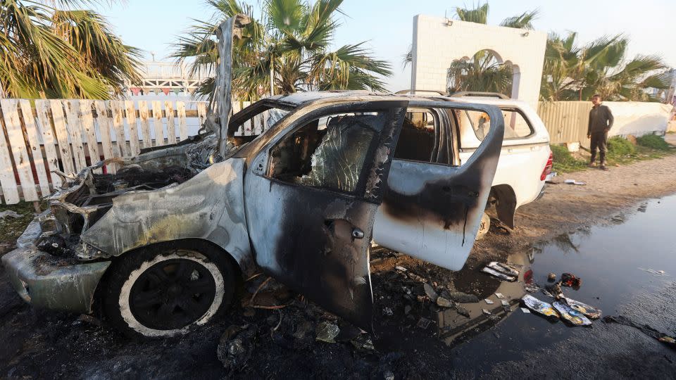 A person looks at a vehicle where aid workers from the World Central Kitchen were killed in an airstrike - Ahmed Zakot/Reuters