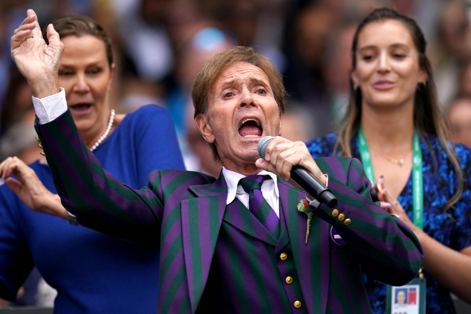 Sir Cliff Richard entertains the crowd on centre court during day seven of the 2022 Wimbledon Championships.