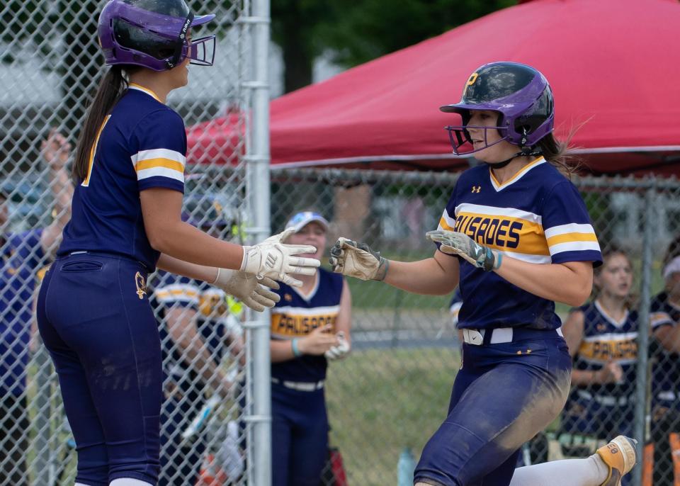 Palisades' Karlye Teman greets Ashley Amato at homeplate on a two-run double by Brooklyn Lucas in a first-round PIAA 3A state playoff softball game against Conwell-Egan, on Monday, June 5, 2023, at Palisades High School in Nockamixon. The Pirates advance to the quarterfinals after defeating the Eagles 9-5.