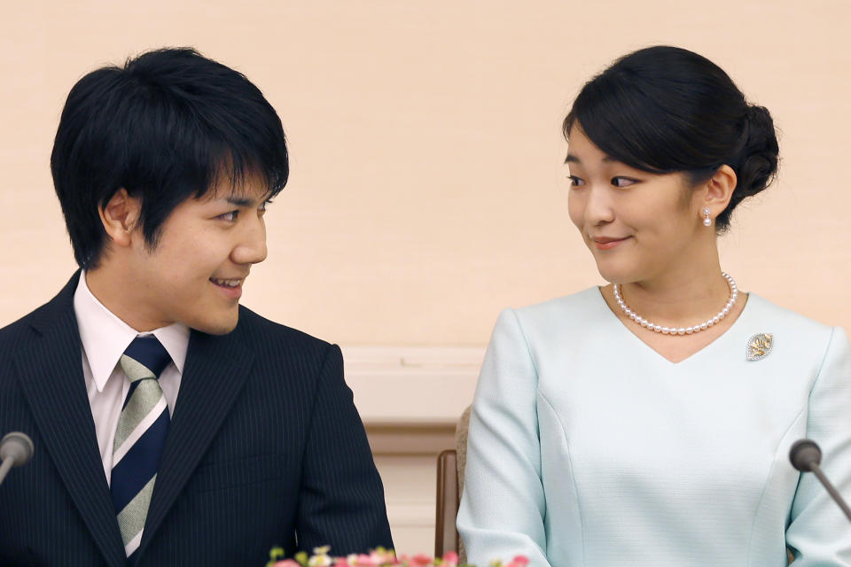 FILE - Japan's Princess Mako and her fiance Kei Komuro look at each other during a press conference at Akasaka East Residence in Tokyo on Sept. 3, 2017. Komuro has passed the New York bar exam, defying detractors back home who had criticized their romance. (AP Photo/Shizuo Kambayashi, Pool, File)
