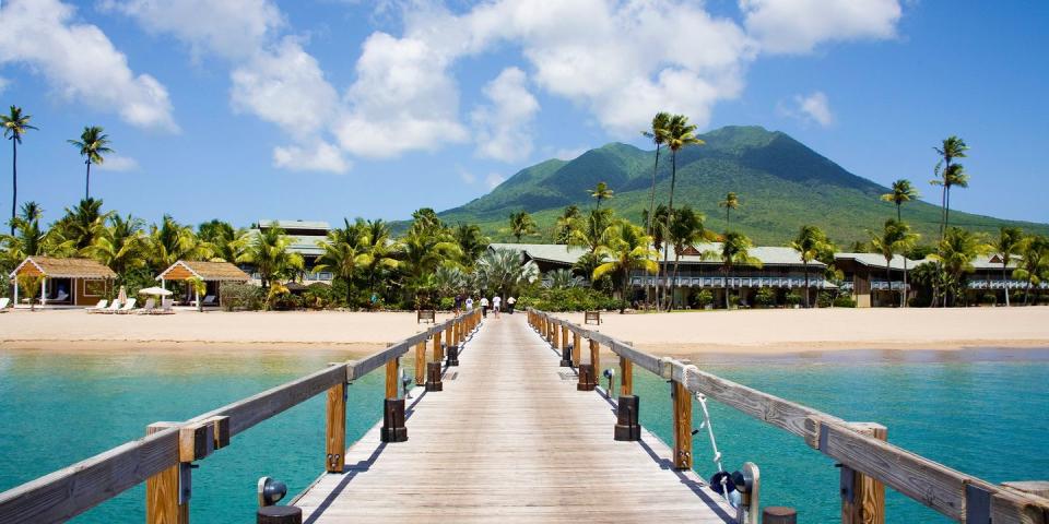 <p>Nevis has always been one of the Caribbean's hidden gems — though it's recently gotten more attention, due to the fact that Alexander Hamilton was born on the island — making it an idyllic honeymoon destination. </p><p>Your days will likely revolve around the island's main beach called <a href="https://www.tripadvisor.com/Attraction_Review-g147378-d148420-Reviews-Pinney_s_Beach-Charlestown_Nevis_St_Kitts_and_Nevis.html" rel="nofollow noopener" target="_blank" data-ylk="slk:Pinney's;elm:context_link;itc:0;sec:content-canvas" class="link ">Pinney's</a>, where you can swim, snorkel, go kayaking, and indulge in a couples' massage in the spa at the beachfront <a href="https://www.tripadvisor.com/Hotel_Review-g147378-d184851-Reviews-Four_Seasons_Resort_Nevis_West_Indies-Charlestown_Nevis_St_Kitts_and_Nevis.html" rel="nofollow noopener" target="_blank" data-ylk="slk:Four Seasons;elm:context_link;itc:0;sec:content-canvas" class="link ">Four Seasons</a>. Pre-dinner, try a Killer Bee rum-based cocktail at <a href="https://www.tripadvisor.com/Restaurant_Review-g147378-d982569-Reviews-Sunshine_s_Beach_Lounge-Charlestown_Nevis_St_Kitts_and_Nevis.html%22%20%5Ct%20%22_blank" rel="nofollow noopener" target="_blank" data-ylk="slk:Sunshine's;elm:context_link;itc:0;sec:content-canvas" class="link ">Sunshine's</a>, a funky barefoot beach bar.</p>