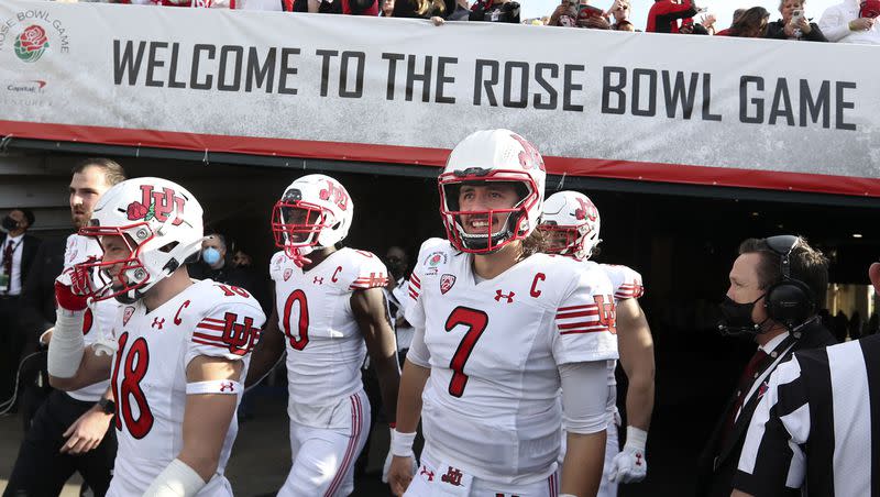 Utah Utes long snapper Keegan Markgraf, wide receiver Britain Covey, linebacker Devin Lloyd, quarterback Cameron Rising and defensive end Mika Tafua walk onto the field for the game against Ohio State in the Rose Bowl in Pasadena, Calif., on Saturday, Jan. 1, 2022.