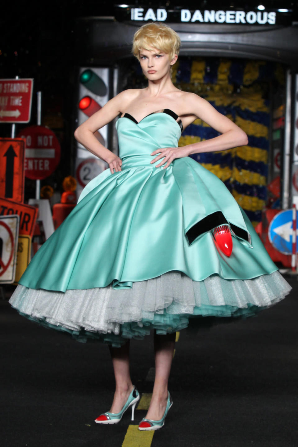 A model wears a baby blue dress with tailfins on Moschino’s spring 2016 runway.