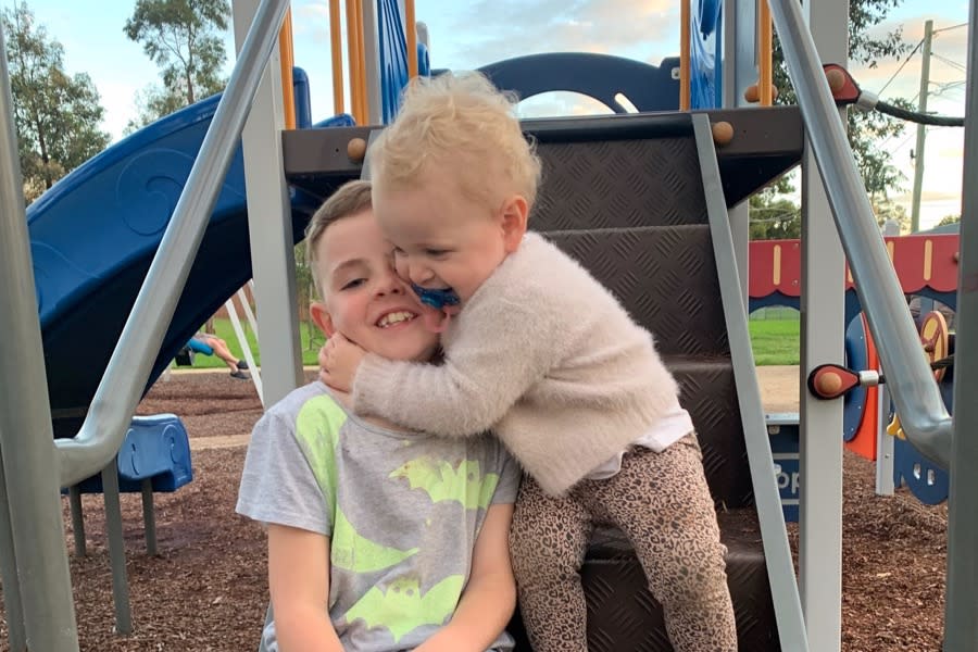 Lola hugs her brother, Ruben, who called triple-0 after she was found dead in Caringbah.