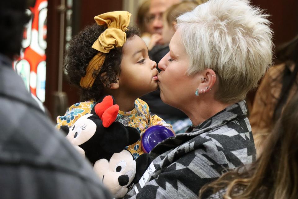 Rosie Daniels and grandmother Londi Blackwell have a tender moment during the National Adoption Day event Nov. 18 at the Randall County Courthouse in Canyon.