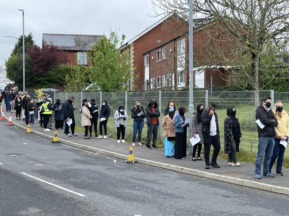 <p>People queuing for vaccinations in Bolton</p> (PA Wire)