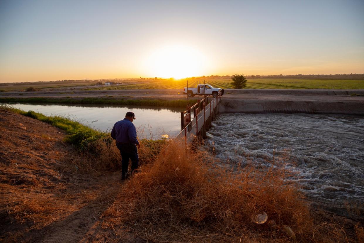 Water master Robert Rios walks down to irrigation gates near the border wall in El Paso County Water Improvement District No. 1 in July 2023. The "ditch riders" frequently find dead migrants trapped in the fast moving water. "It’s something you can’t shake," Rios said of the smell of death. "It stays with you."