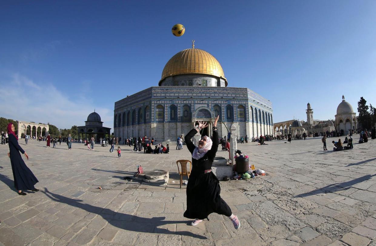 A Palestinian girl plays with a ball outside of the Al-Aqsa Mosque compound in the old city of Jerusalem. <a href="https://media.gettyimages.com/id/672383194/photo/topshot-palestinian-israel-religion-islam.jpg?s=612x612&w=gi&k=20&c=t9WkHH1lF85JtWrqYIm99b5o1In5Ibg729a0jjWTo50=" rel="nofollow noopener" target="_blank" data-ylk="slk:Mahmud Hams/AFP via Getty Images;elm:context_link;itc:0;sec:content-canvas" class="link ">Mahmud Hams/AFP via Getty Images</a>