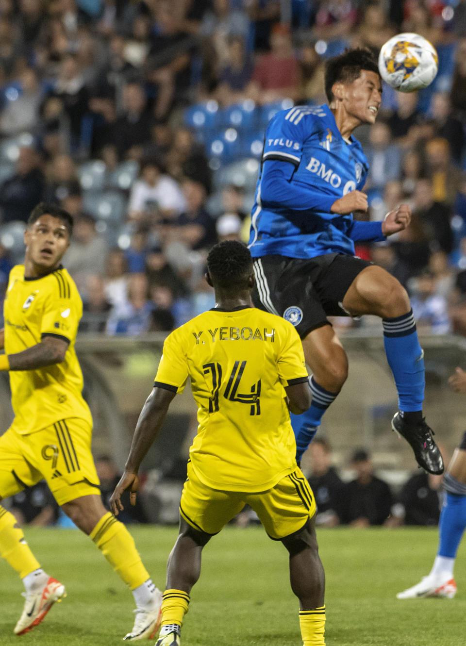 CF Montreal's Matko Miljevic heads the ball as Columbus Crew's Yaw Yeboah defends during the second half of an MLS soccer match Saturday, Sept. 2, 2023, in Montreal. (Peter McCabe/The Canadian Press via AP)