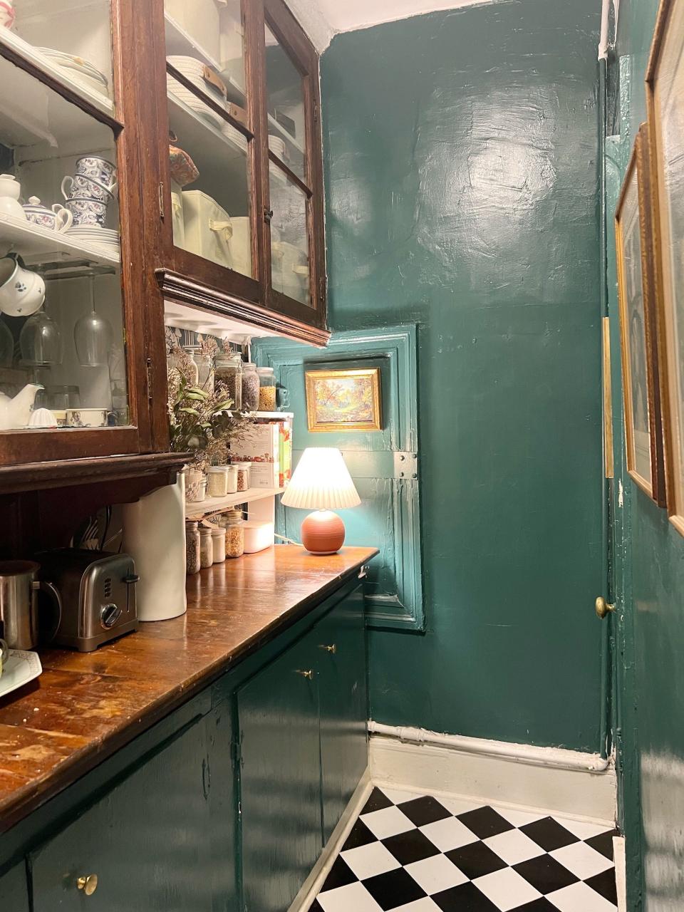 A kitchen with green walls.