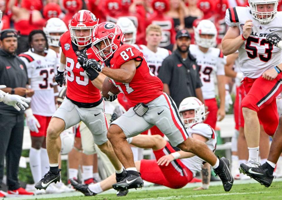 Georgia receiver Mekhi Mews (87) returns a punt for a touchdown during the Bulldogs’ victory over Ball State Saturday in Athens.