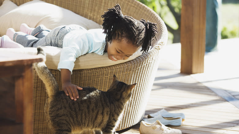 Girl petting cat