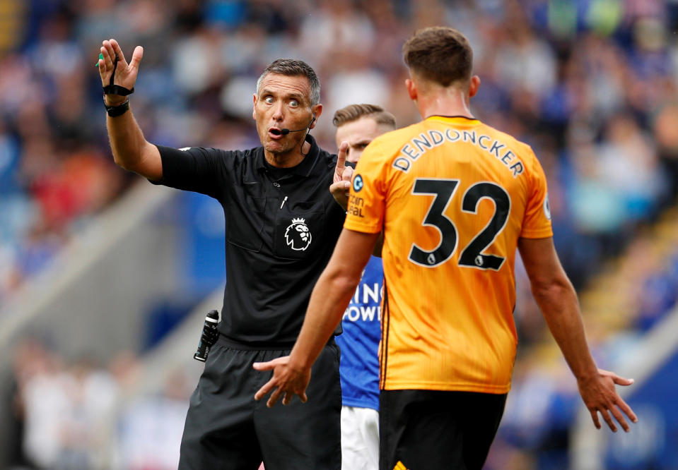 Soccer Football - Premier League - Leicester City v Wolverhampton Wanderers - King Power Stadium, Leicester, Britain - August 11, 2019  Referee Andre Marriner gestures as Wolverhampton Wanderers' Leander Dendoncker reacts  Action Images via Reuters/John Sibley  EDITORIAL USE ONLY. No use with unauthorized audio, video, data, fixture lists, club/league logos or "live" services. Online in-match use limited to 75 images, no video emulation. No use in betting, games or single club/league/player publications.  Please contact your account representative for further details.