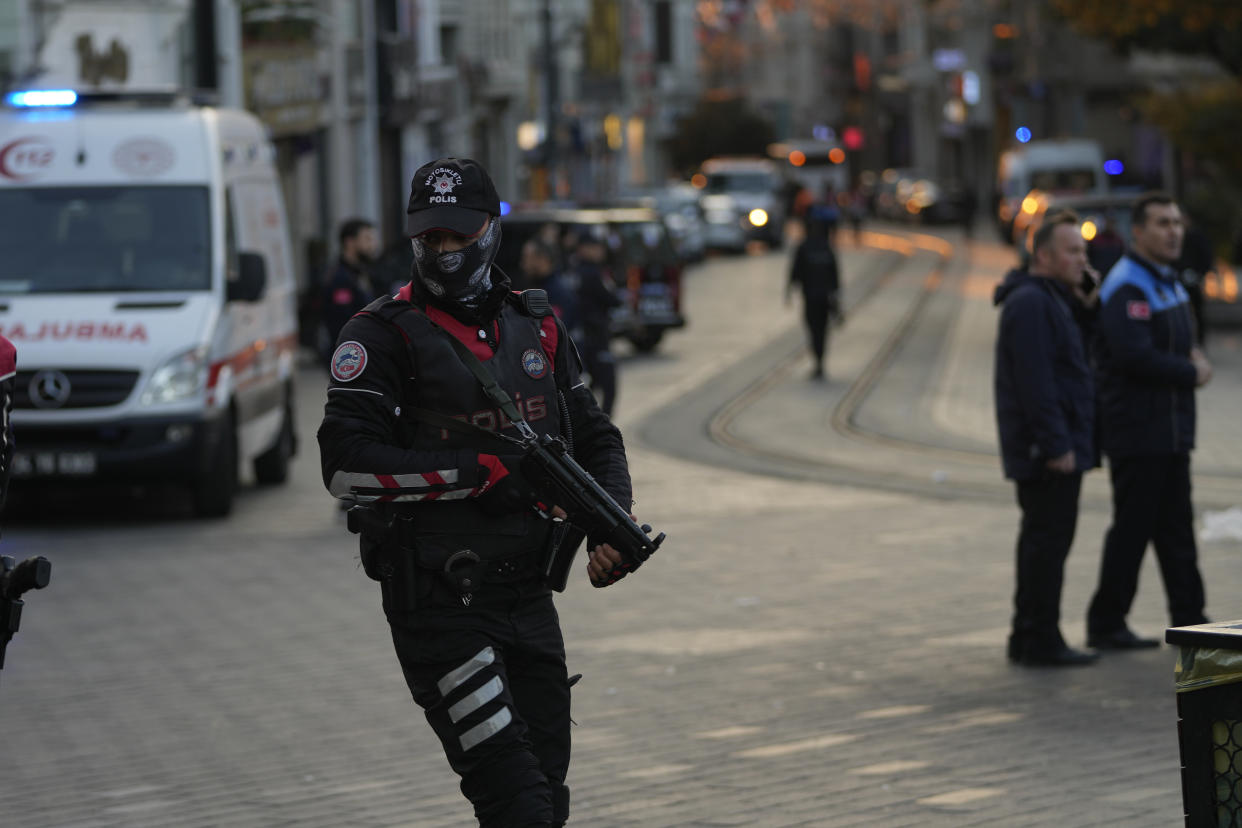 Security and ambulances at the scene after an explosion on Istanbul's popular pedestrian Istiklal Avenue, Sunday, Nov. 13, 2022. Istanbul Gov. Ali Yerlikaya tweeted that the explosion occurred at about 4:20 p.m. (1320 GMT) and that there were deaths and injuries, but he did not say how many. The cause of the explosion was not clear. (AP Photo/Francisco Seco)