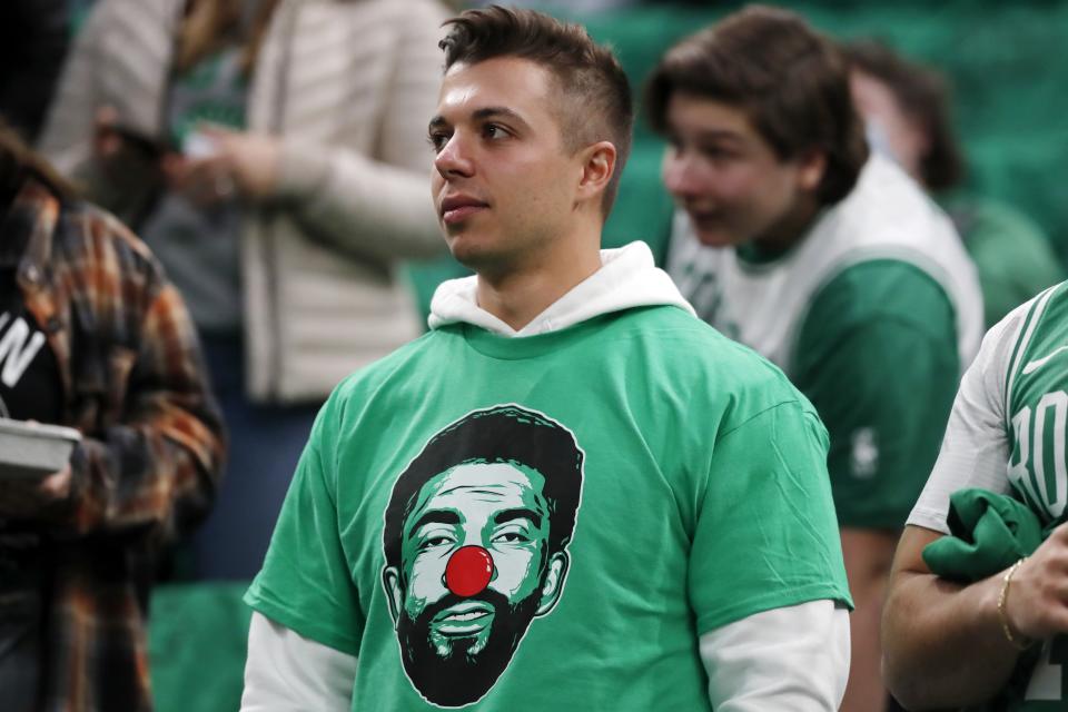 A Boston Celtics fan waits for Game 2 of the team's NBA basketball first-round Eastern Conference playoff series against the Brooklyn Nets, Wednesday, April 20, 2022, in Boston. (AP Photo/Michael Dwyer)