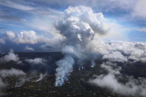 Smoke rises Leilani Estates neighborhood on May 6, 2018.