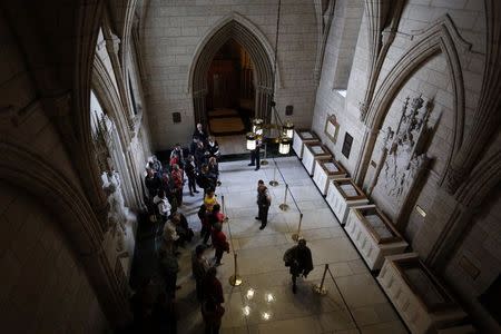 Tourists stand in the Hall of Honour outside the doors to the Library of Parliament on Parliament Hill in Ottawa October 27, 2014. REUTERS/Blair Gable