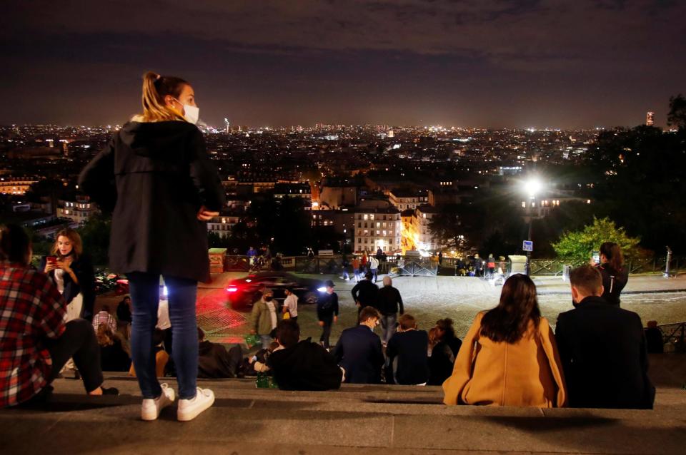 People enjoy the view from Montmartre in Paris before the nightly curfewREUTERS