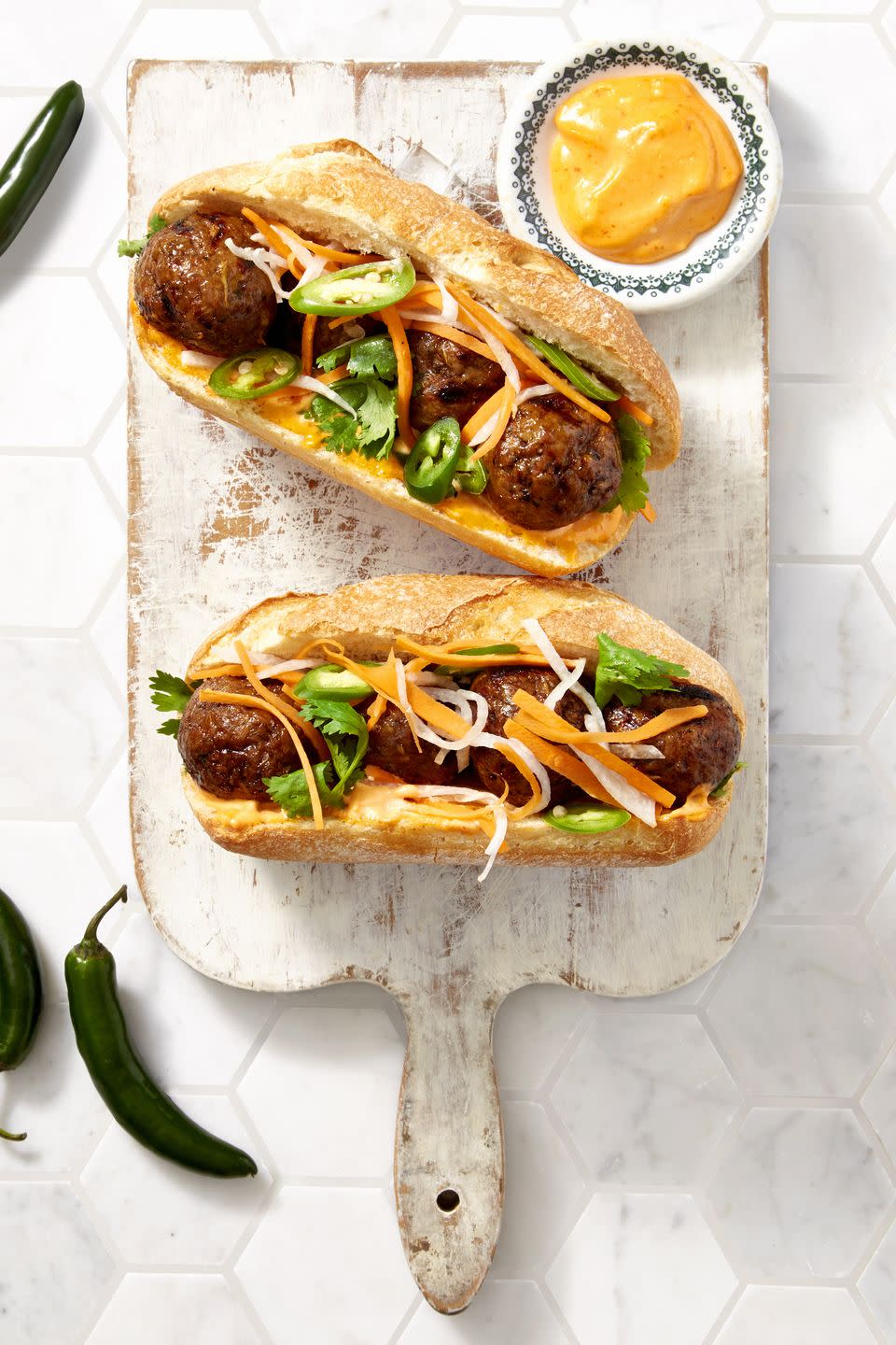 <p>This Asian riff on a classic Italian sub is on fire thanks to an easy homemade sriracha mayo.</p><p><em><a href="https://www.goodhousekeeping.com/food-recipes/a39934/sriracha-meatball-hoagies-recipe/" rel="nofollow noopener" target="_blank" data-ylk="slk:Get the recipe for Sriracha Meatball Hoagies »;elm:context_link;itc:0;sec:content-canvas" class="link "><span class="redactor-invisible-space">Get the recipe for Sriracha Meatball Hoagies »</span> </a></em></p>