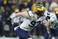 Michigan defensive end Aidan Hutchinson (97) rushes up field during the second half of the Big Ten championship NCAA college football game against Iowa, Saturday, Dec. 4, 2021, in Indianapolis. (AP Photo/Darron Cummings)