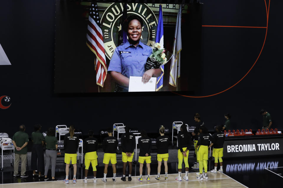 FILE - In this July 30, 2020, file photo members of the Seattle Storm stand in front of a photo of Breonna Taylor before a WNBA basketball game against the Washington Mystics in Bradenton, Fla. Taylor was killed in her home by police officers. Americans' suggestions of suitable statues for President Donald Trump's planned National Garden of American Heroes are in, and they look considerably different from the predominantly white worthies that the administration has locked in for many of the pedestals. Lehigh County, Pennsylvania Commissioner Amy Zanelli, suggested George Floyd, Breonna Taylor, and other Black Americans whose killings by police sparked massive street protests. (AP Photo/Chris O'Meara, File)