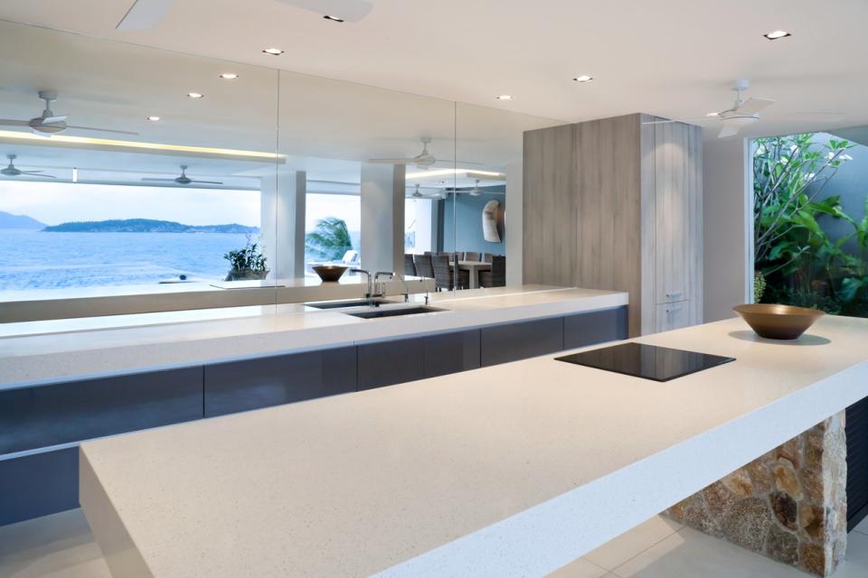Concrete countertops are the focus in this photo of a bright modern kitchen.