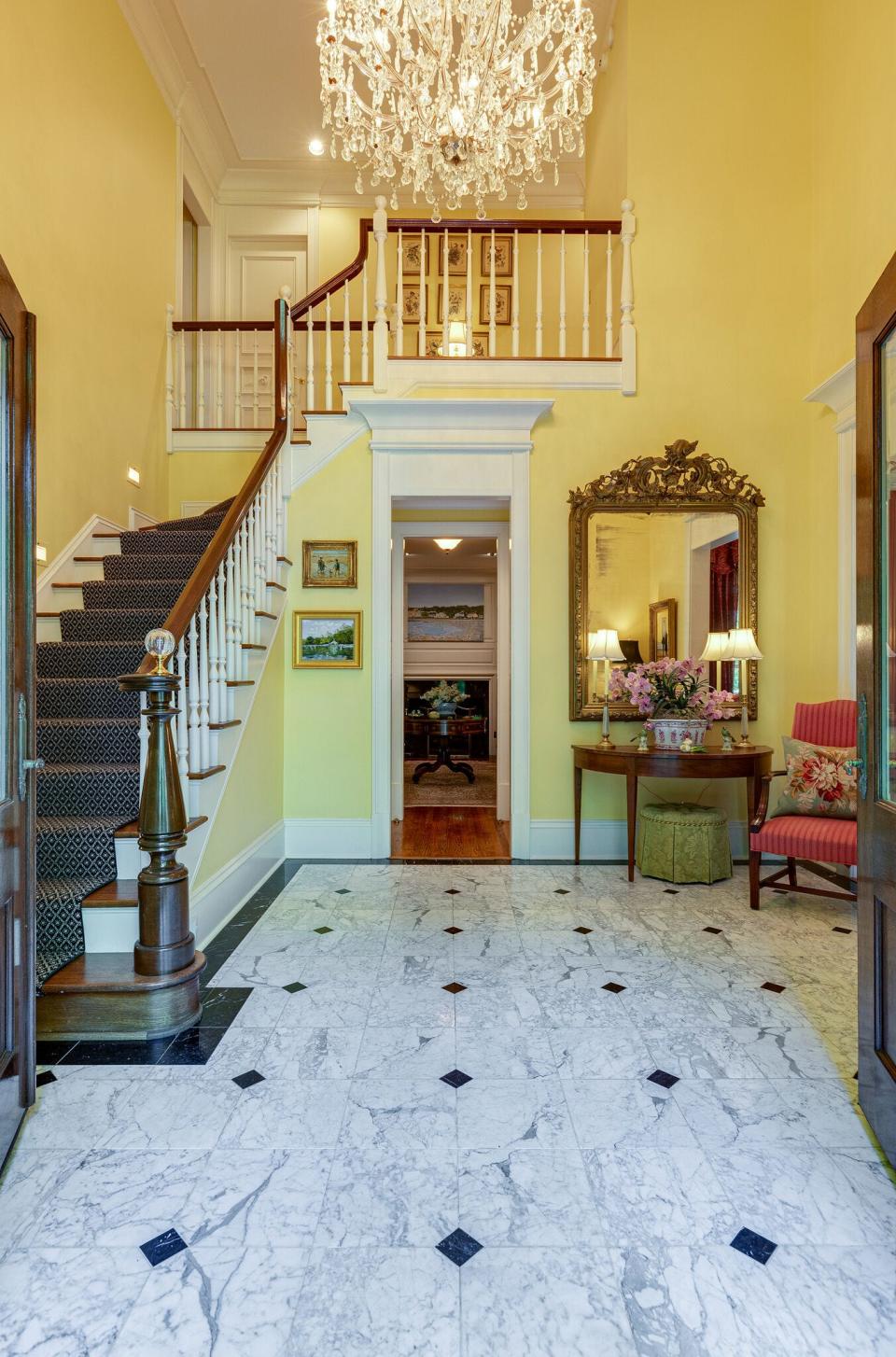 The foyer of 62 Annandale in Nashville with its curved staircase and crystal chandelier, sets an elegant tone.